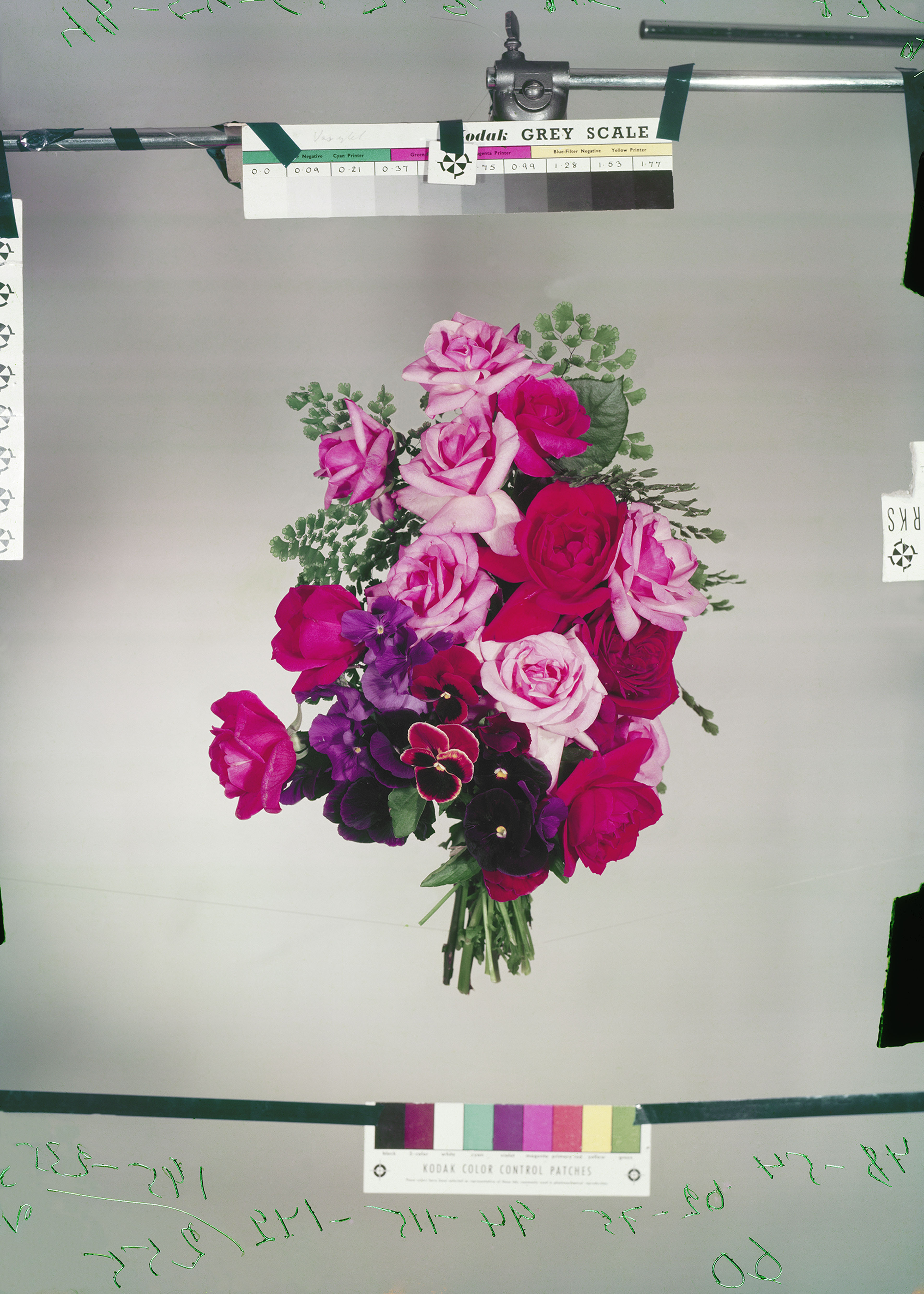 Photo by Claire Aho, a bouquet of flowers is suspended in mid-air for a photoshoot. 