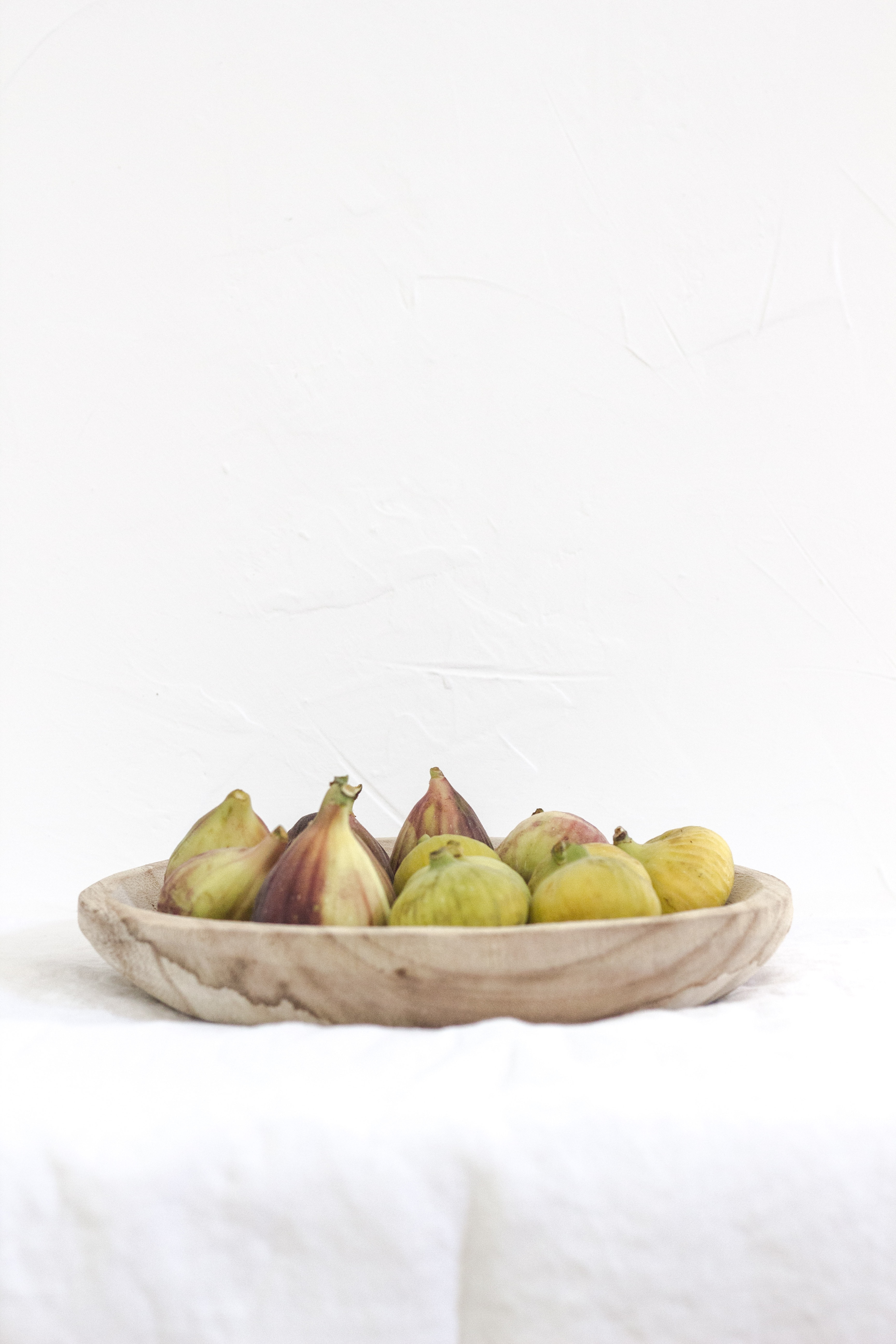 A still life photo of a bowl of figs